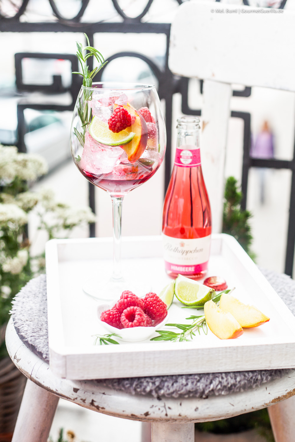 Hibiscus infused raspberry secco punch with peach and rosemary